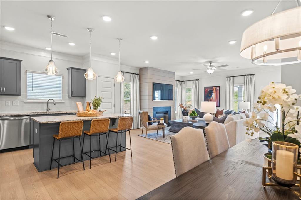 16 Willow Circle Rock Spring, GA 30739 - Photo 7 of 30 a large living room with stainless steel appliances kitchen island granite countertop furniture and a dining table