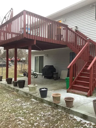 a view of a house with porch patio furniture and backyard