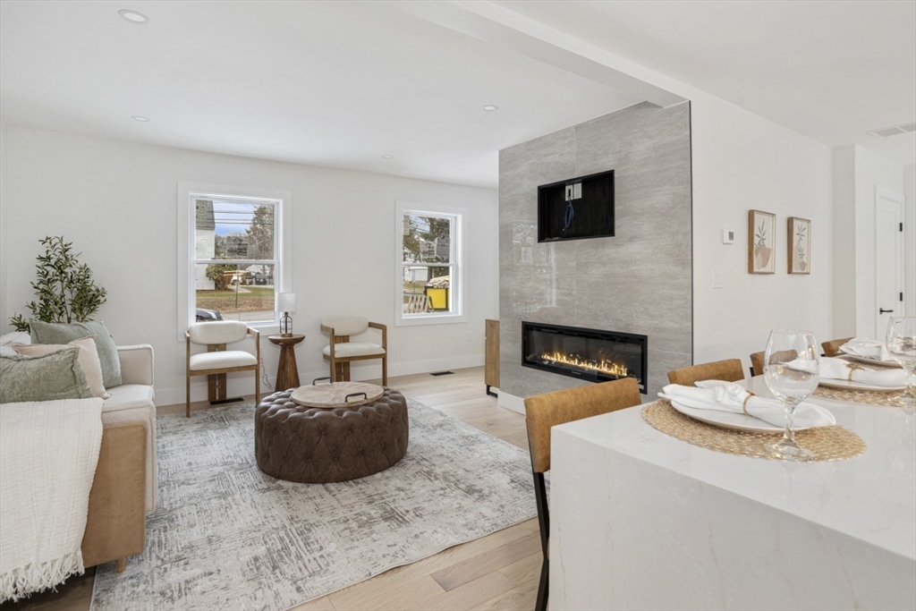 63 Kellogg Street Framingham, MA 01701 - Photo 14 of 38 a living room with furniture a flat screen tv and a fireplace