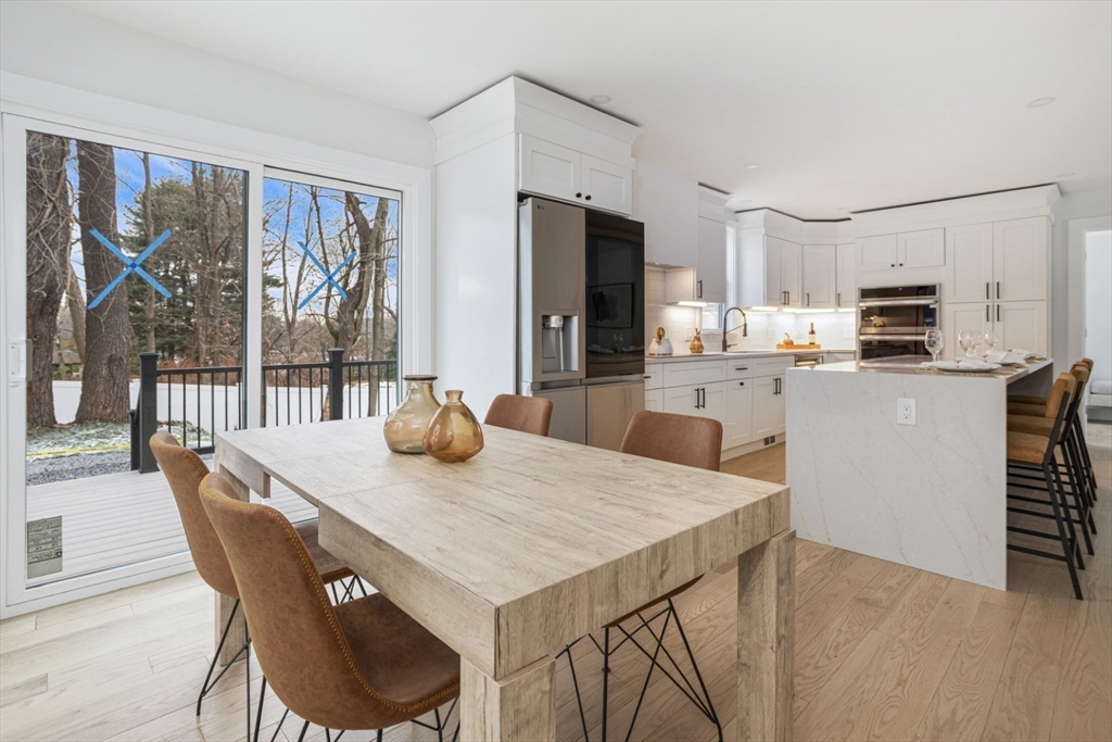 63 Kellogg Street Framingham, MA 01701 - Photo 15 of 38 a kitchen with kitchen island a stove a table and chairs