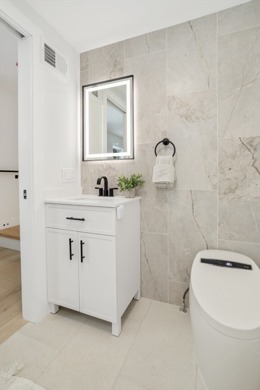 63 Kellogg Street Framingham, MA 01701 - Photo 17 of 38 a bathroom with a sink a toilet and mirror