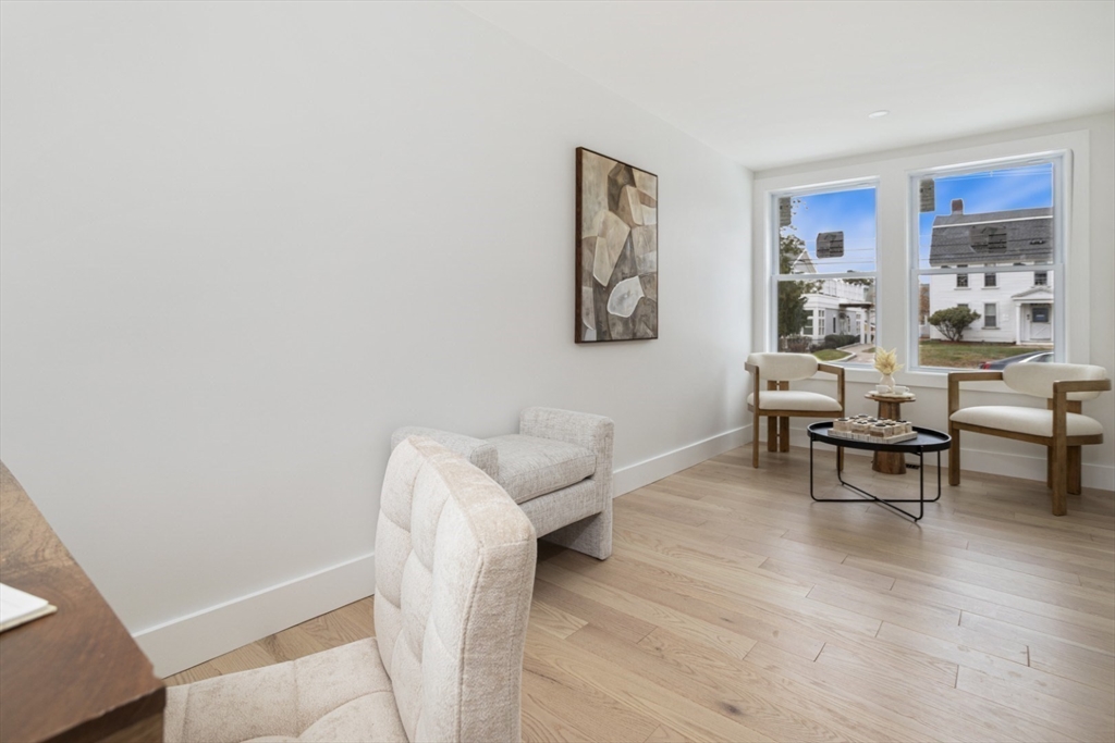 63 Kellogg Street Framingham, MA 01701 - Photo 19 of 38 a living room with furniture and a painting on the wall