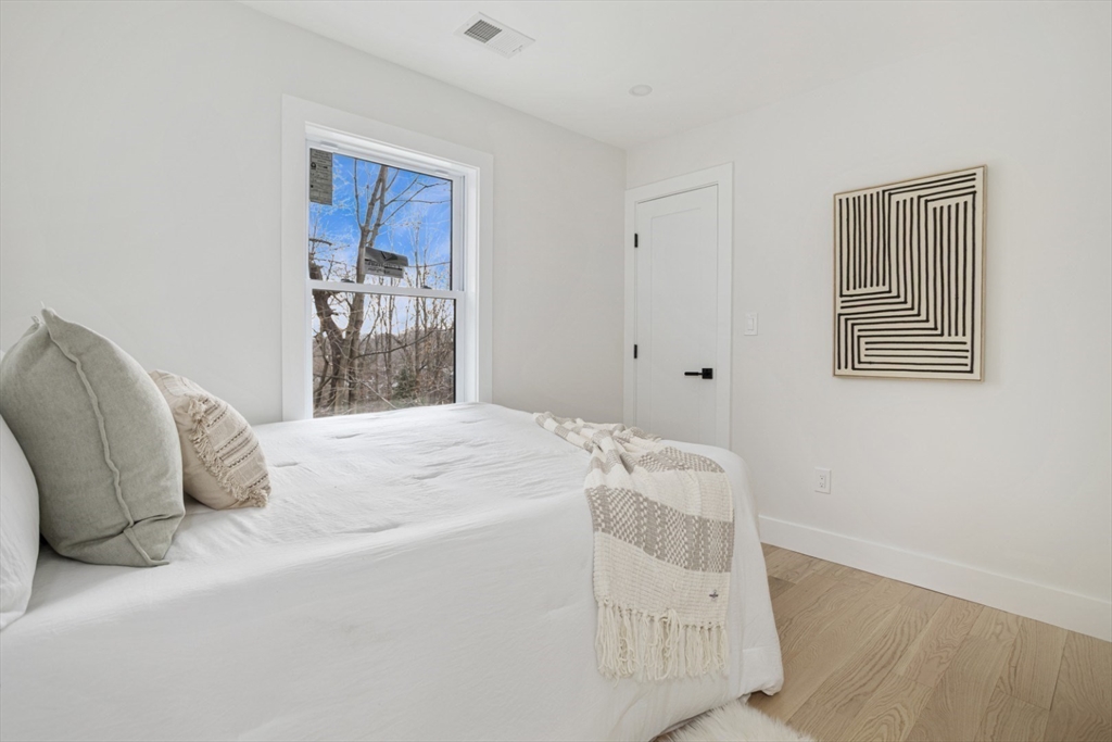 63 Kellogg Street Framingham, MA 01701 - Photo 23 of 38 a bedroom with a bed and a window
