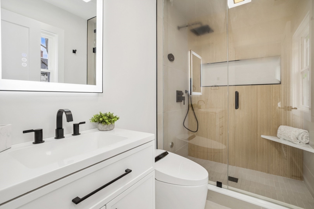63 Kellogg Street Framingham, MA 01701 - Photo 25 of 38 a bathroom with a granite countertop sink a toilet and shower
