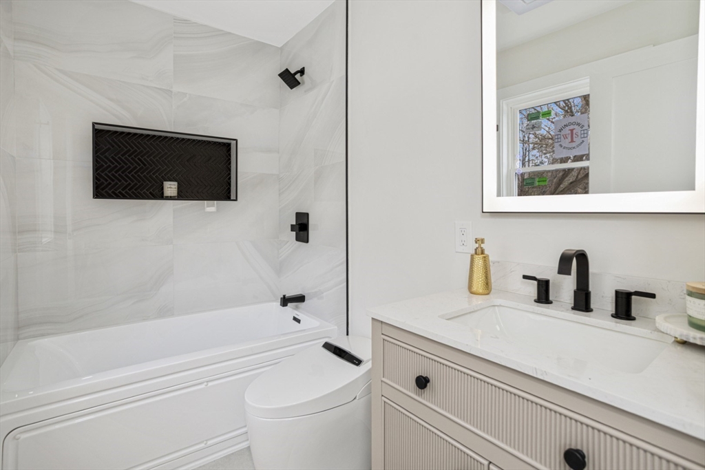 63 Kellogg Street Framingham, MA 01701 - Photo 27 of 38 a bathroom with a sink a toilet and a bathtub