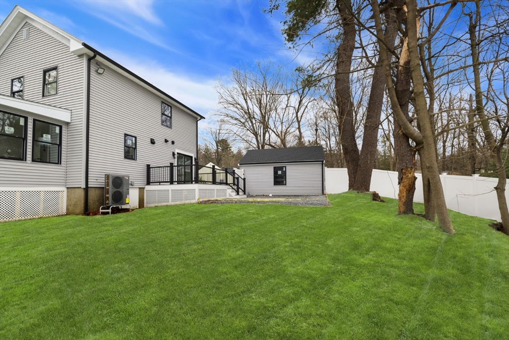 63 Kellogg Street Framingham, MA 01701 - Photo 37 of 38 a view of a house with backyard and a tree