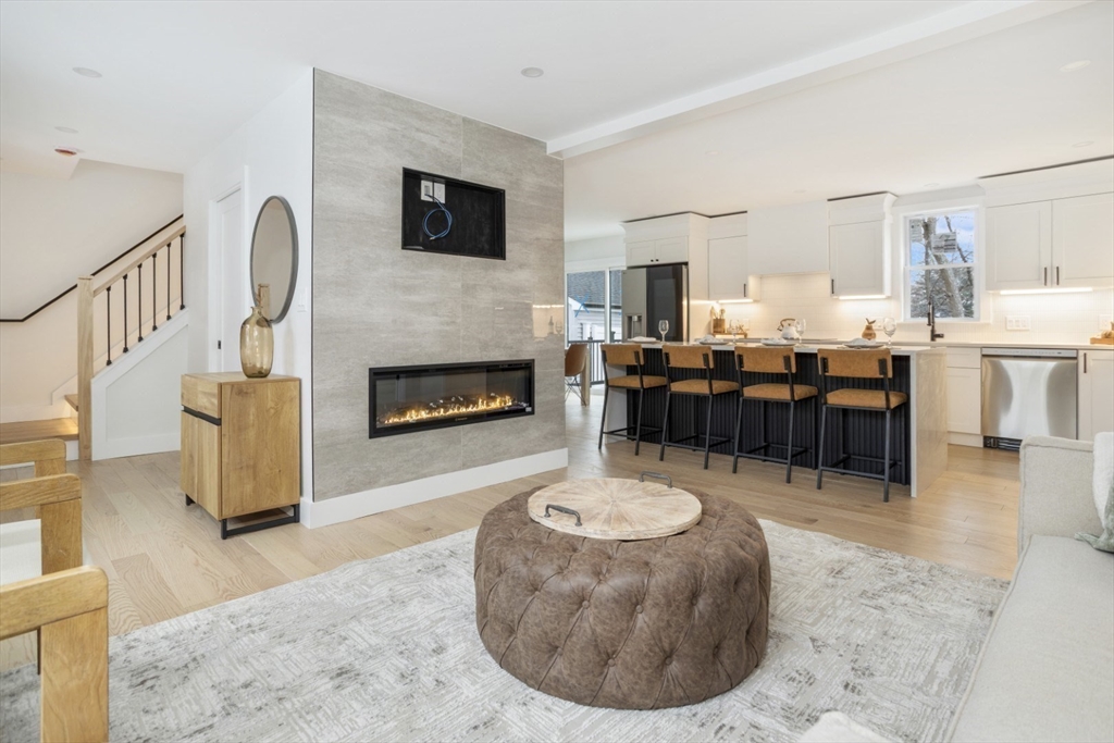 63 Kellogg Street Framingham, MA 01701 - Photo 4 of 38 a living room with furniture a fireplace and a flat screen tv
