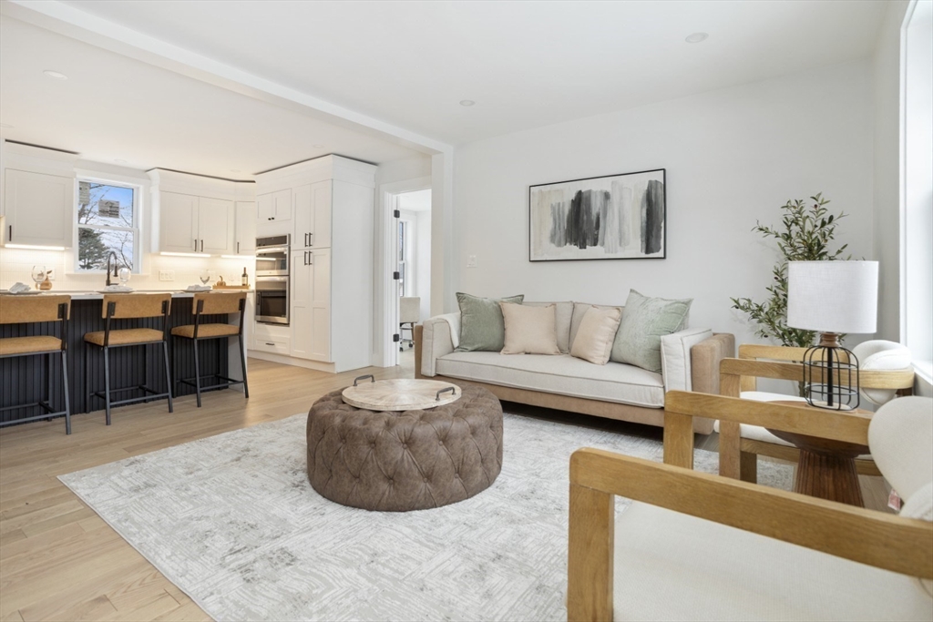 63 Kellogg Street Framingham, MA 01701 - Photo 5 of 38 a living room with furniture and a dining table