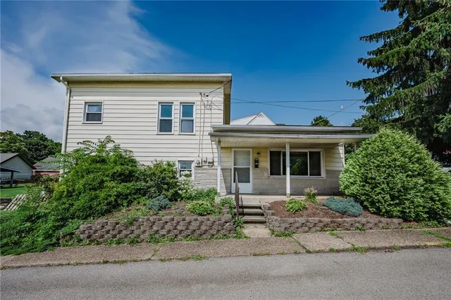 front view of a house with a bench