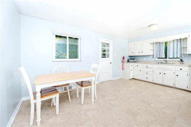 a dining room with a table and chairs
