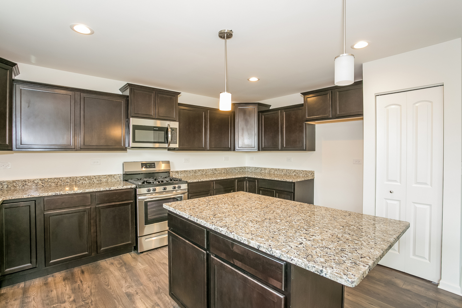 2097 Rownham Hill Road New Lenox, IL 60451 - Photo 4 of 13 a kitchen with stainless steel appliances granite countertop a sink stove and refrigerator