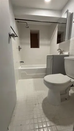 a white toilet sitting next to a bathroom sink