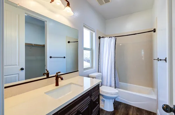 a view of storage and utility room with wooden floor