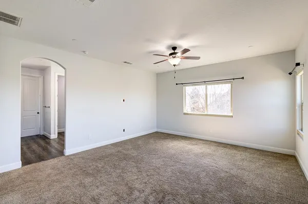 a kitchen with center island wooden floor appliances and a window
