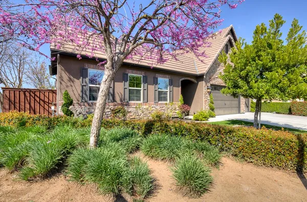 a large kitchen with stainless steel appliances and large windows