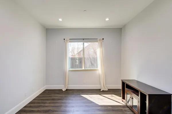 a view of a backyard with a tub and wooden fence