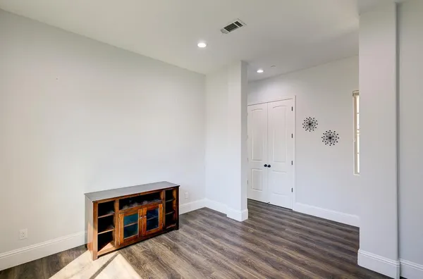 a view of a livingroom with a ceiling fan wooden floor and window