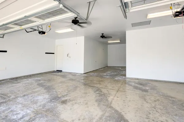 an aerial view of a house with a garden and lake view