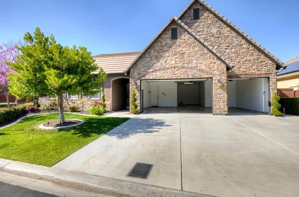 a kitchen with stainless steel appliances granite countertop a sink stove and wooden cabinets