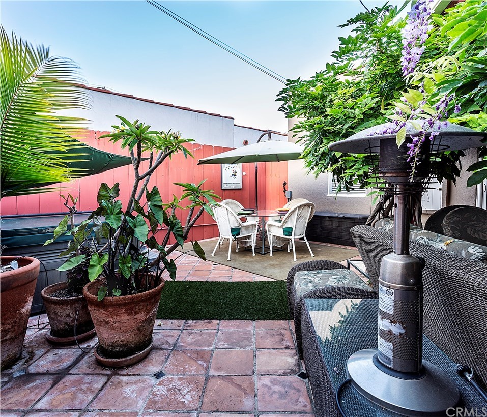 175 Granada Avenue Long Beach, CA 90803 - Photo 25 of 29 Tiled backyard patio with spa dining area and conversation area.