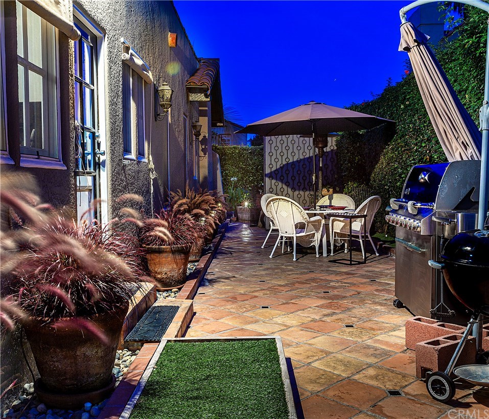 175 Granada Avenue Long Beach, CA 90803 - Photo 27 of 29 South side yard with a door off of the kitchen. A perfect place for outside dining.