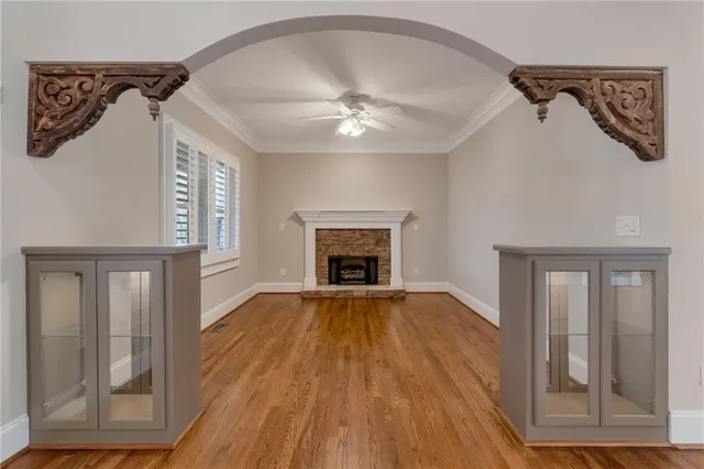 a kitchen with stainless steel appliances granite countertop a sink a stove and a wooden floors