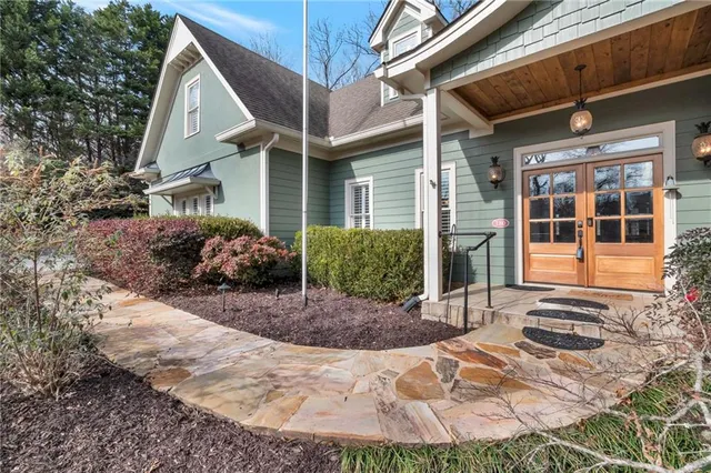 a view of a white house with a yard covered in snow