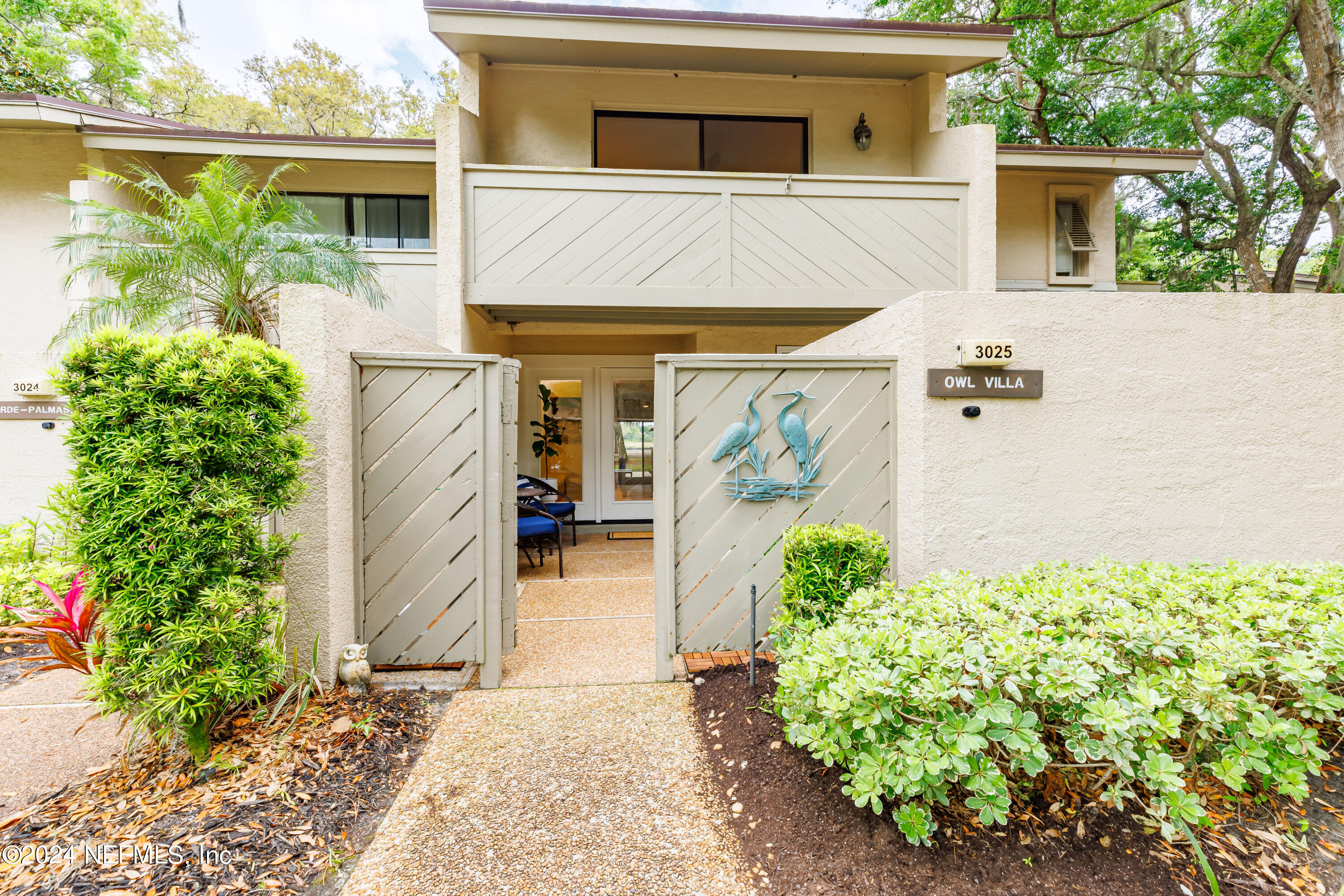 a view of a house with potted plants