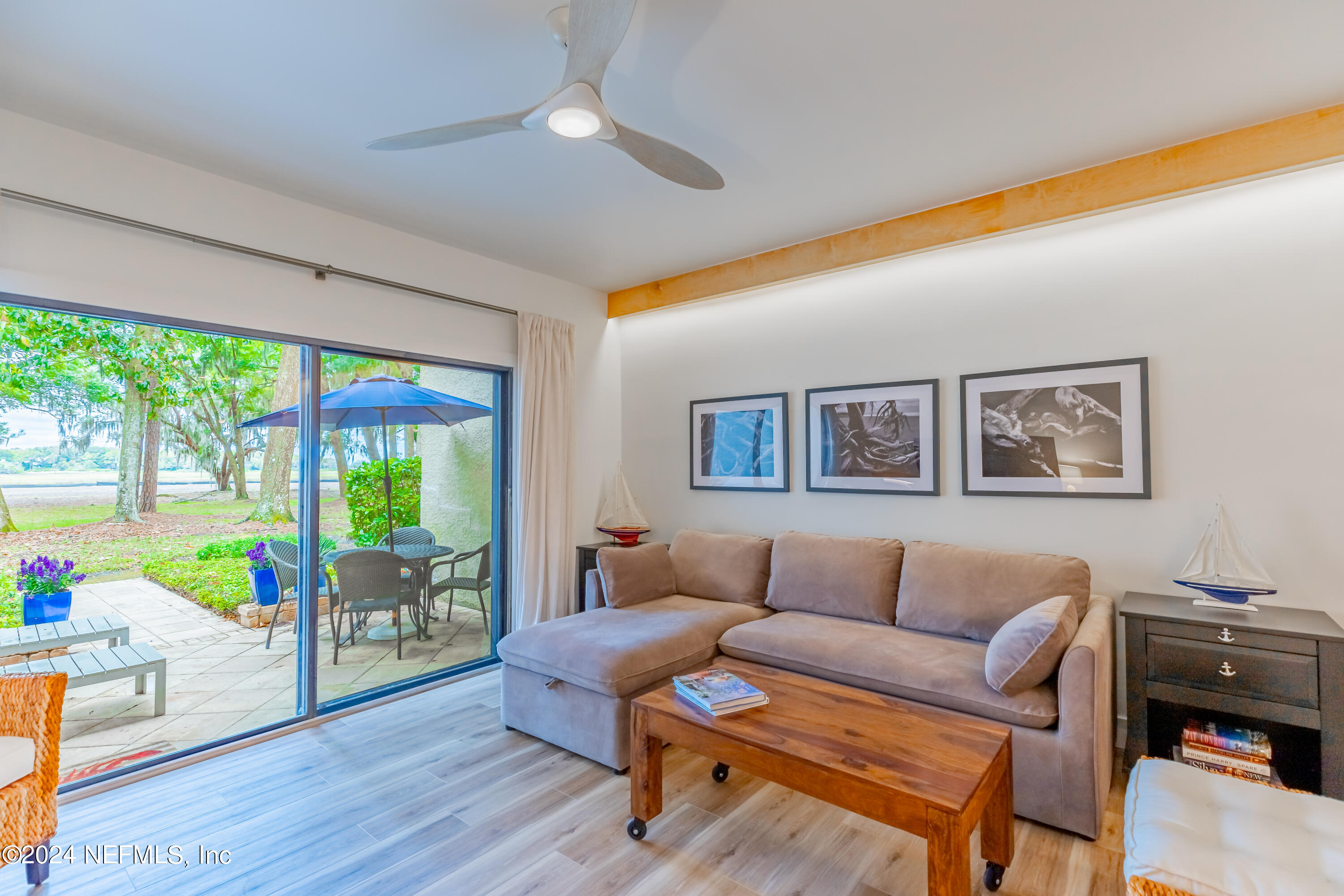 3025 Sea Marsh Road Fernandina Beach, FL 32034 - Photo 15 of 54 a living room with furniture and a floor to ceiling window