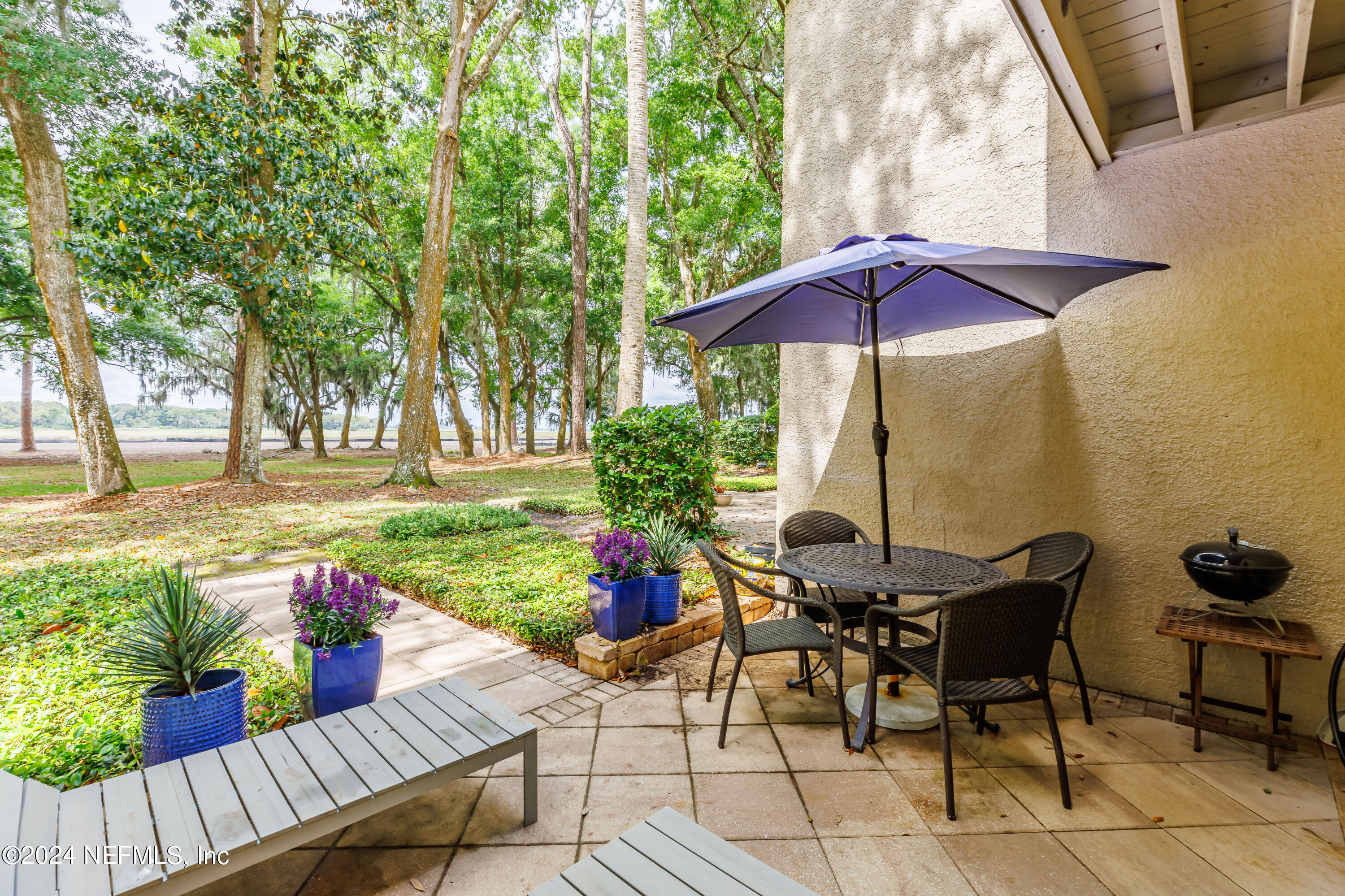 3025 Sea Marsh Road Fernandina Beach, FL 32034 - Photo 16 of 54 a view of a tables and chairs under an umbrella