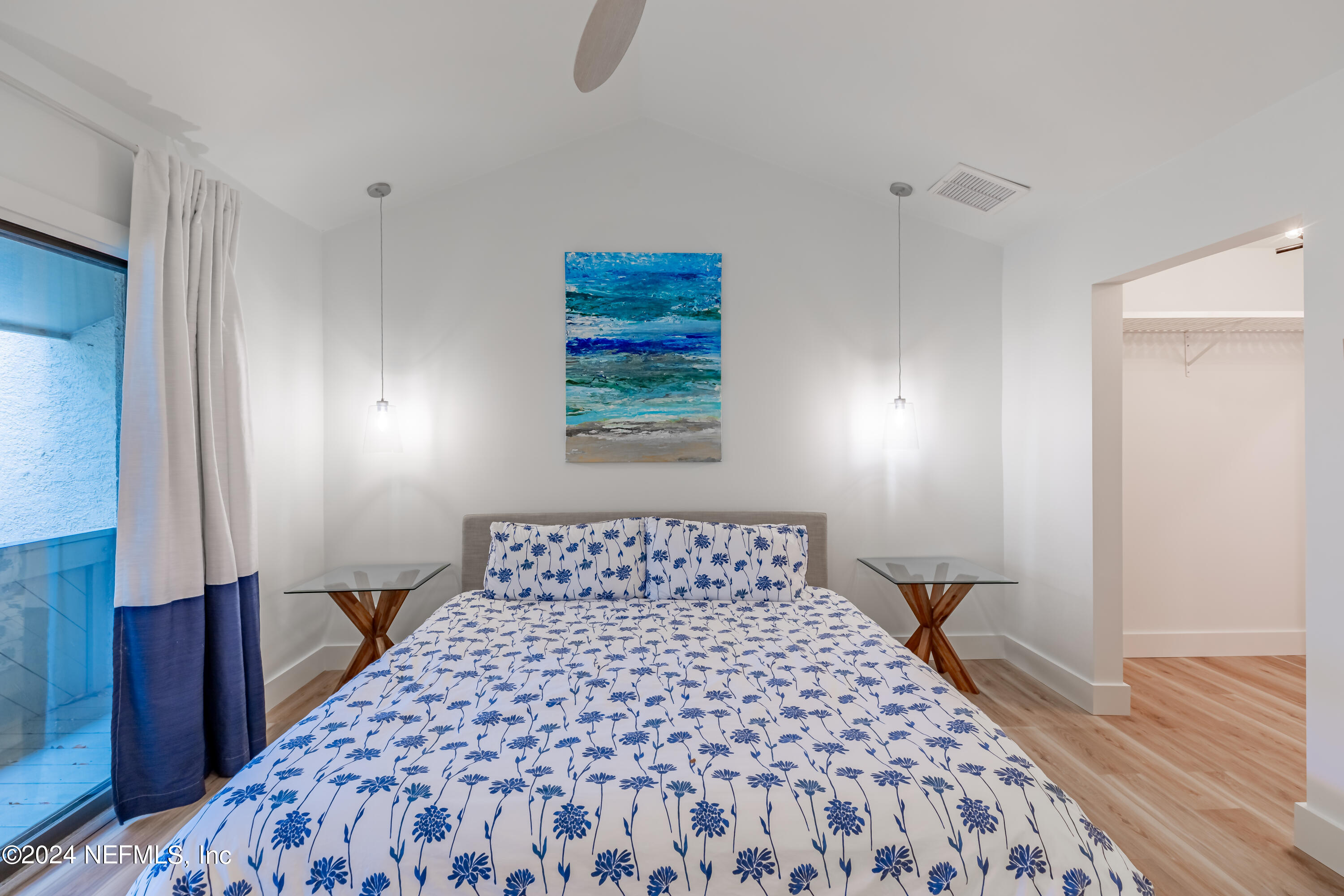 3025 Sea Marsh Road Fernandina Beach, FL 32034 - Photo 21 of 54 a bedroom with a large bed and a wooden floor