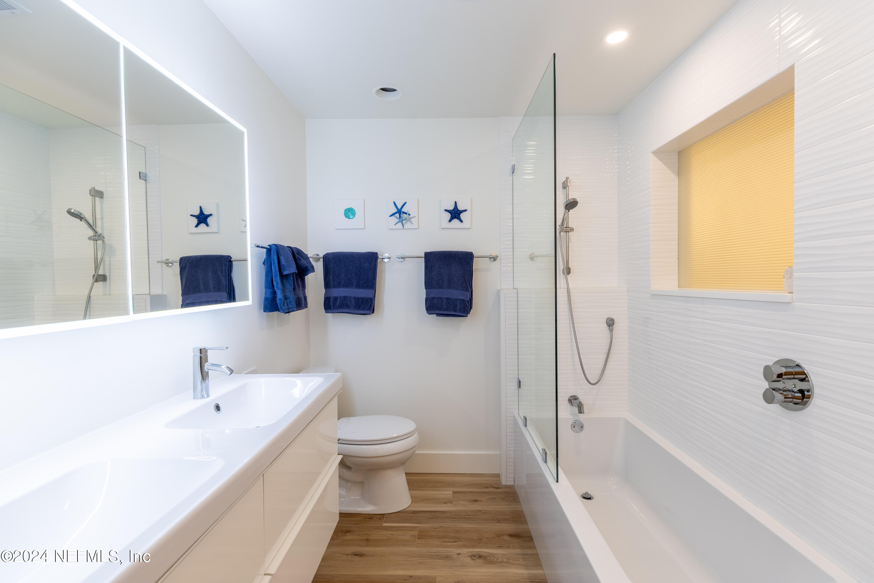 3025 Sea Marsh Road Fernandina Beach, FL 32034 - Photo 26 of 54 a spacious bathroom with a tub sink and mirror
