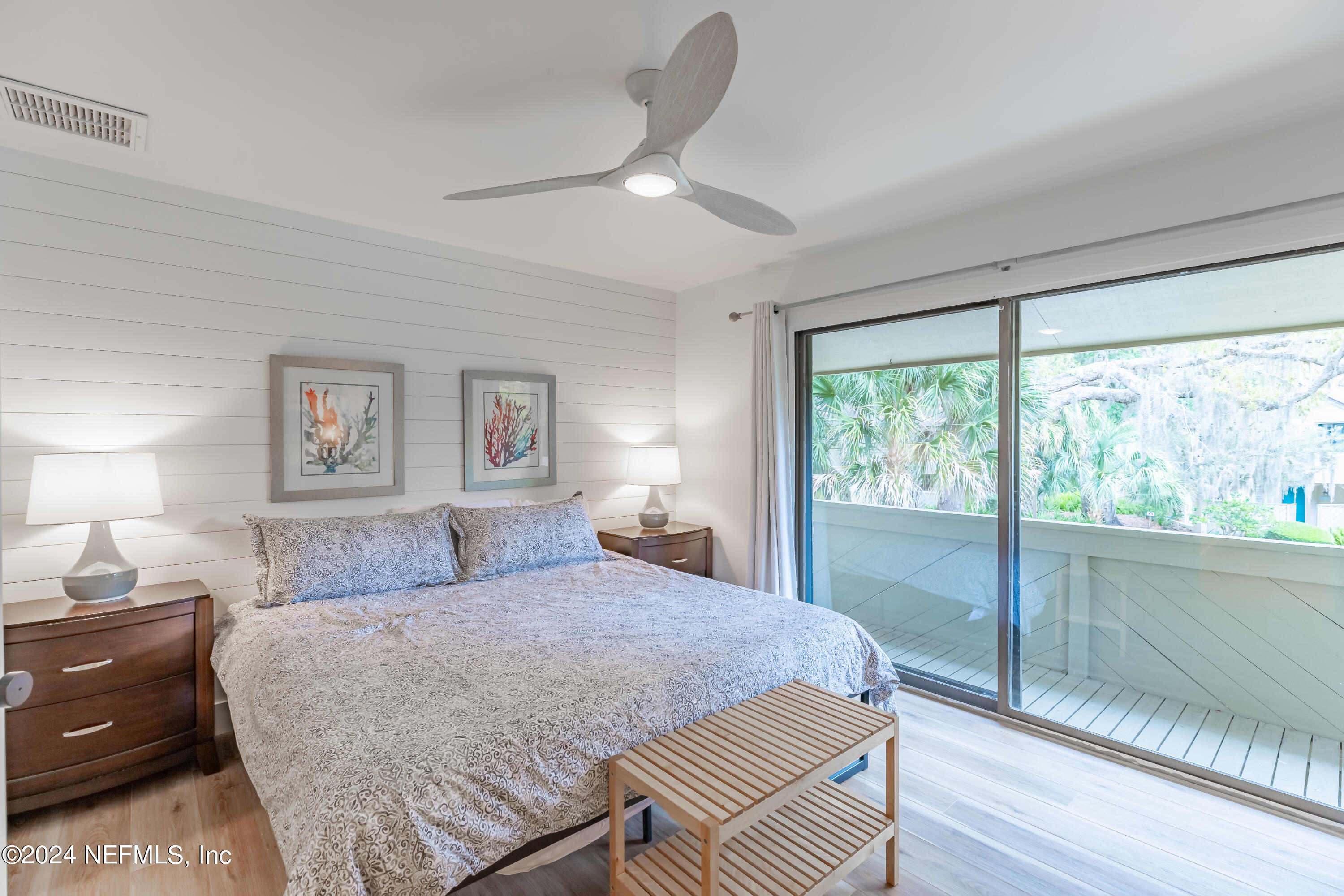 3025 Sea Marsh Road Fernandina Beach, FL 32034 - Photo 28 of 54 a bedroom with a large bed and a night stand