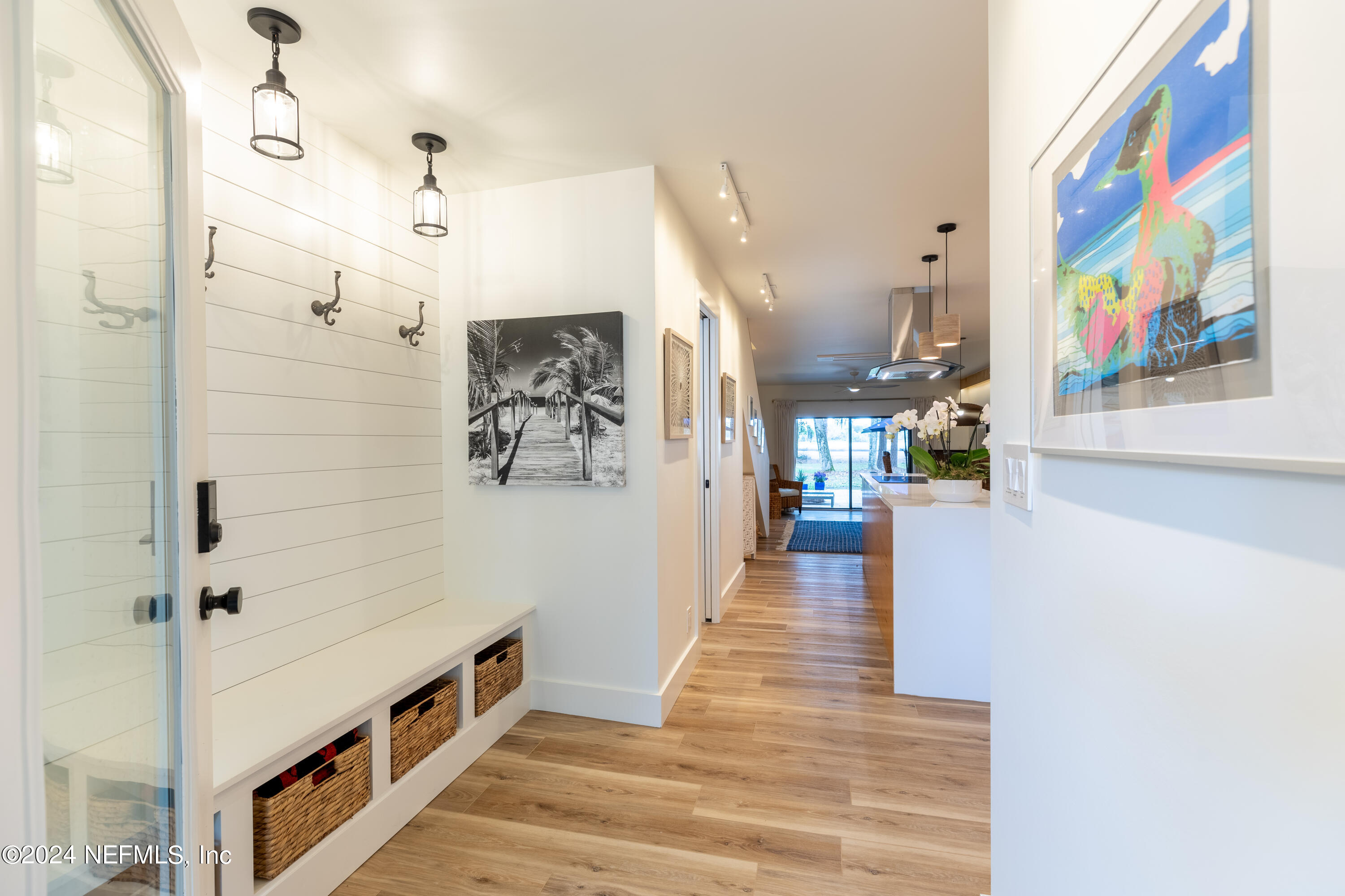 3025 Sea Marsh Road Fernandina Beach, FL 32034 - Photo 3 of 54 a view of a hallway with wooden floor and staircase