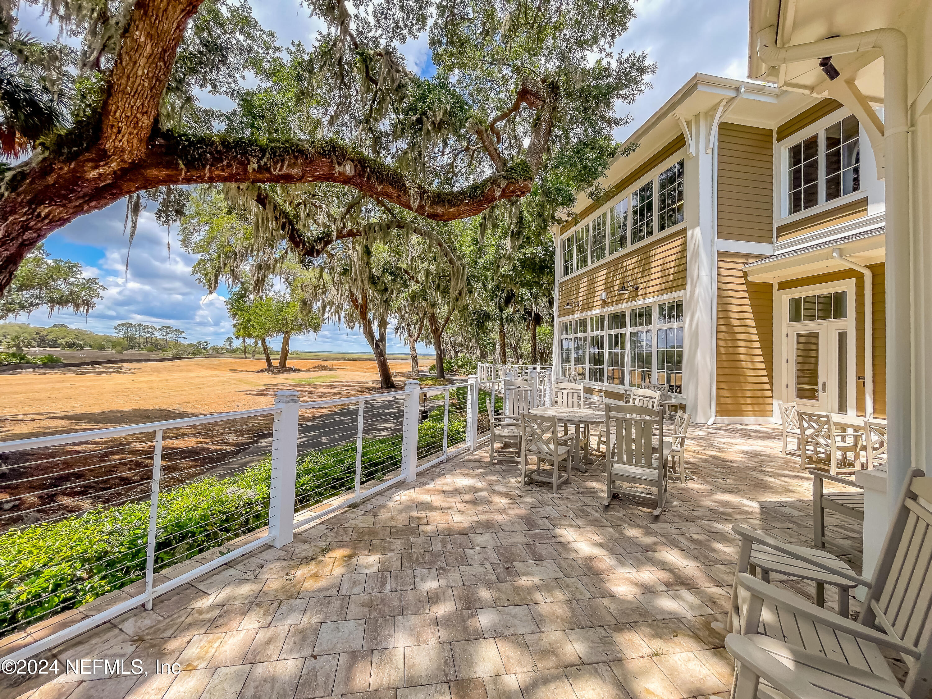 3025 Sea Marsh Road Fernandina Beach, FL 32034 - Photo 48 of 54 a view of a brick house with large trees and a yard