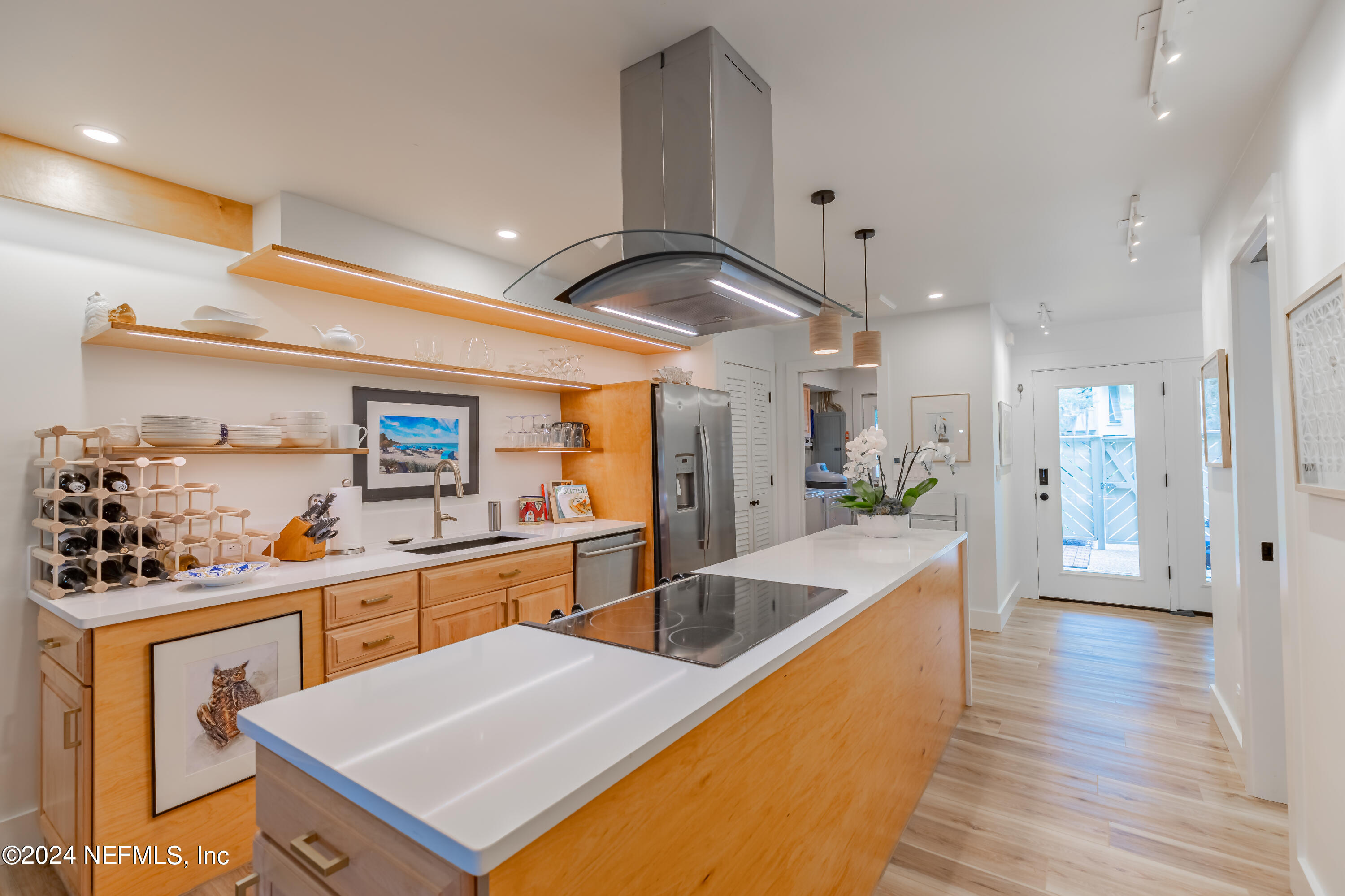 3025 Sea Marsh Road Fernandina Beach, FL 32034 - Photo 7 of 54 a kitchen with stainless steel appliances kitchen island granite countertop a sink and cabinets