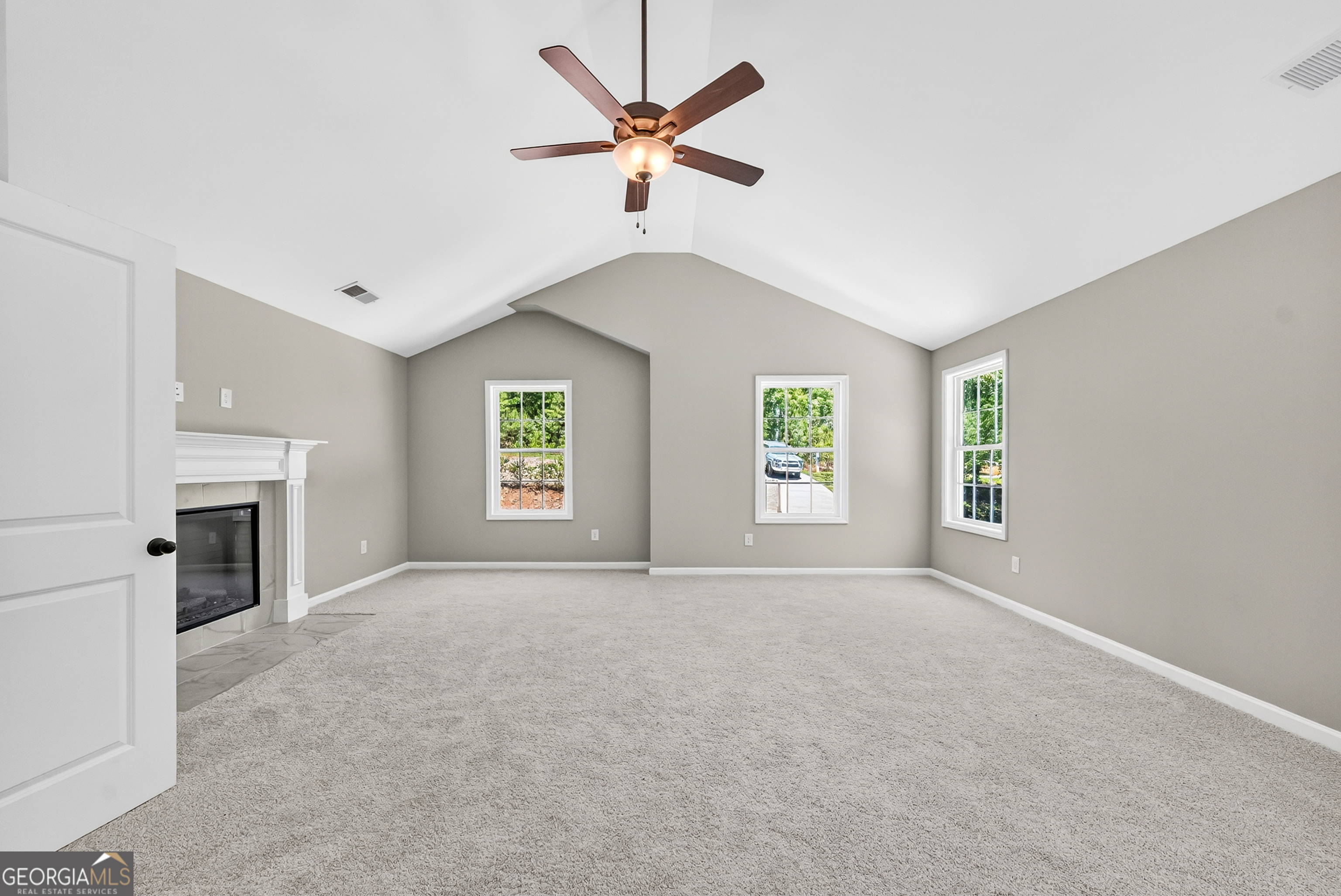38 Oak Ridge Drive, Unit 26 Waverly Hall, GA 31831 - Photo 20 of 37 an empty room with windows and fireplace