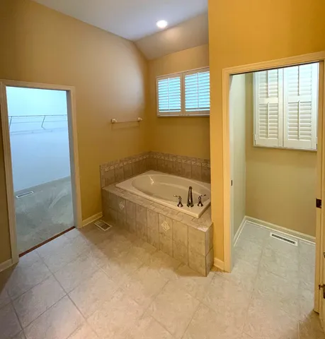 a bathroom with a bathtub and shower