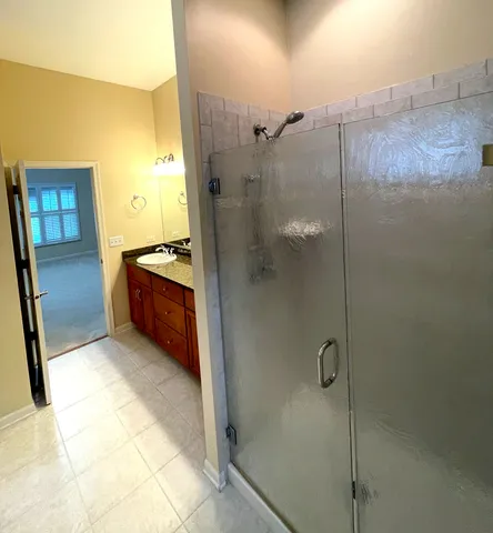 a view of a big room with windows and chandelier fan
