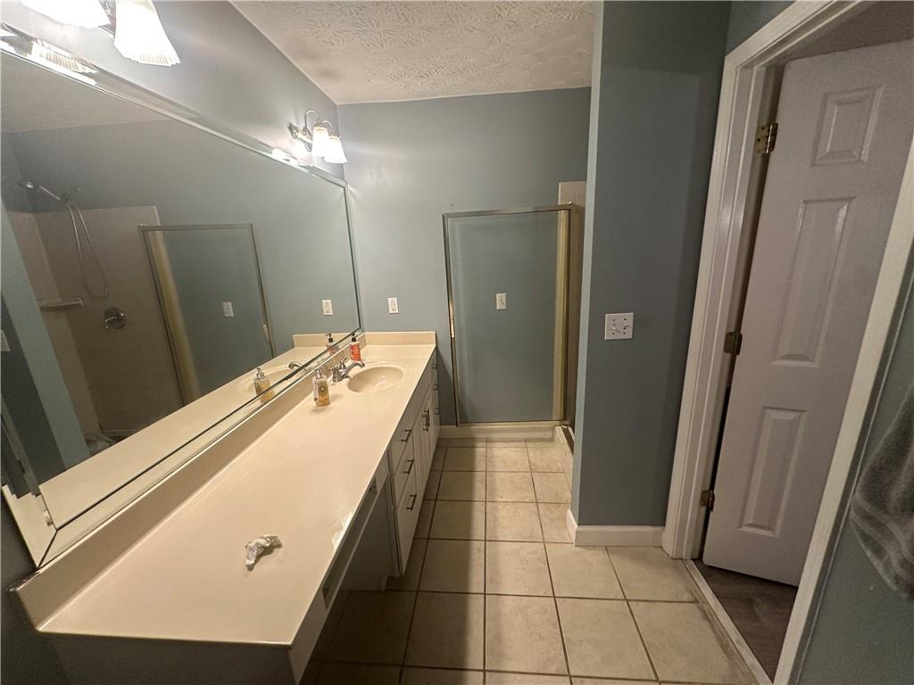 34 Deer Trail Stockbridge, GA 30281 - Photo 19 of 44 a bathroom with a double vanity sink a mirror and a shower