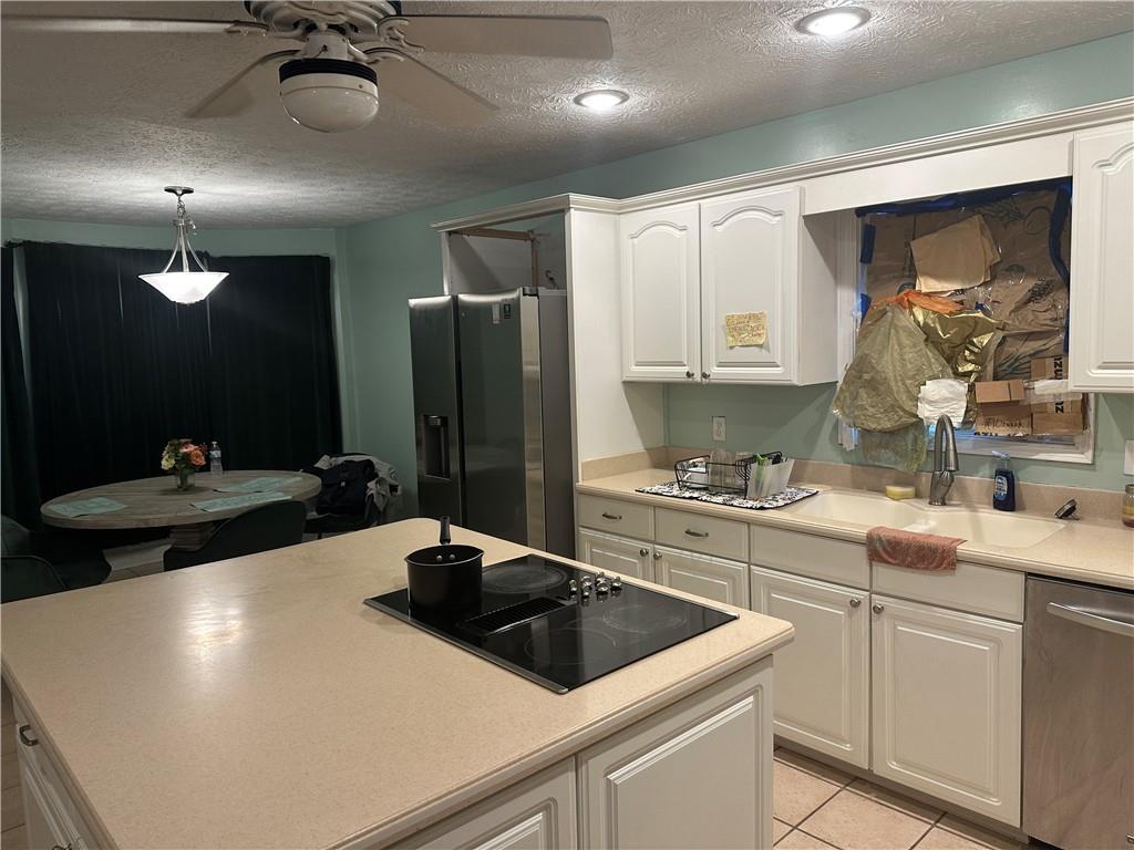 34 Deer Trail Stockbridge, GA 30281 - Photo 5 of 44 a kitchen with stainless steel appliances a sink a stove and a refrigerator