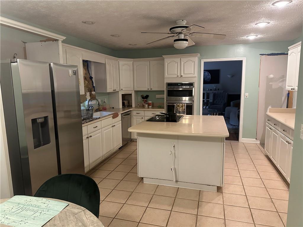 34 Deer Trail Stockbridge, GA 30281 - Photo 6 of 44 a kitchen with stainless steel appliances a refrigerator sink and cabinets