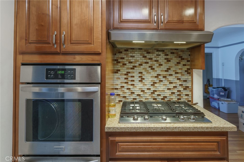 346 West School Street Compton, CA 90220 - Photo 14 of 29 a kitchen with granite countertop a stove top oven and cabinets