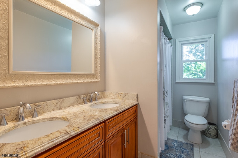 14 Ash Lane Randolph, NJ 07869 - Photo 12 of 22 a bathroom with a granite countertop sink toilet and mirror