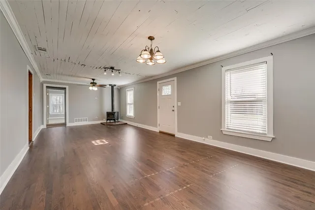 a view of a livingroom with wooden floor and a window
