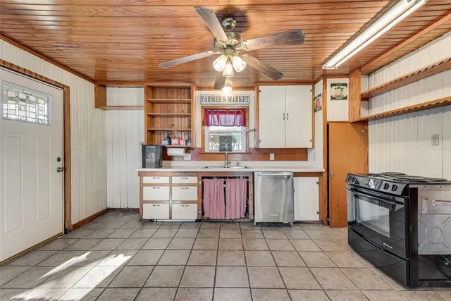 a kitchen with a stove top oven cabinets and a refrigerator