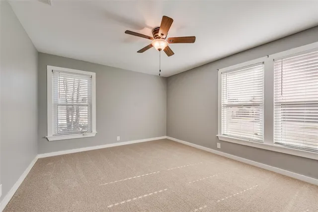 a view of a livingroom with a ceiling fan and window
