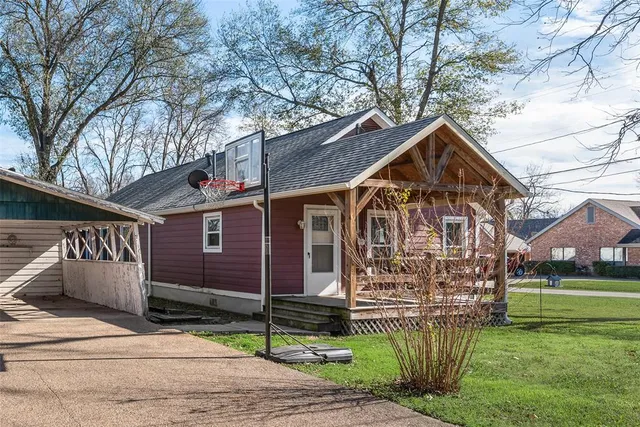 a front view of a house with a garden