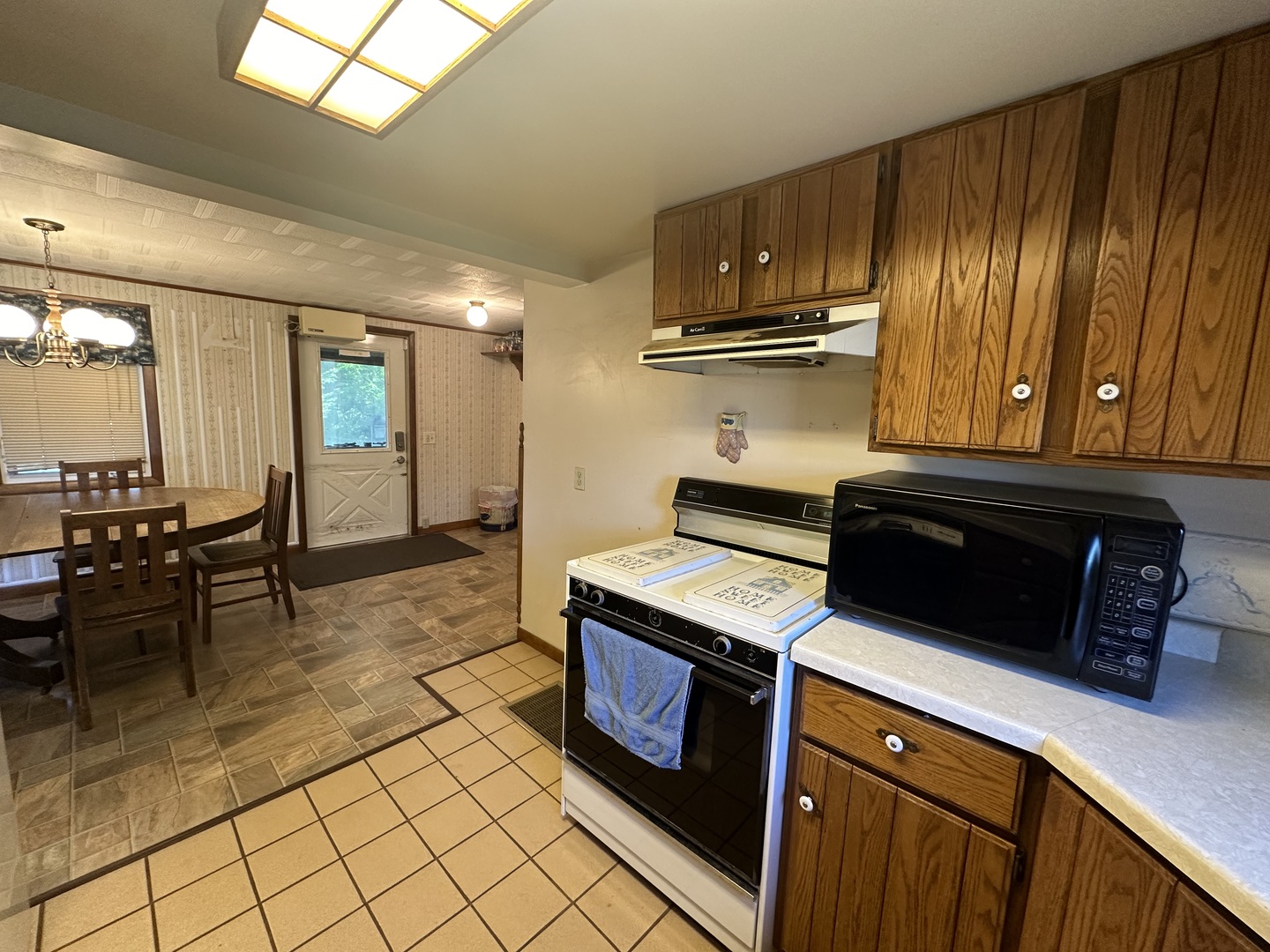 13629 Garden Plain Road Morrison, IL 61270 - Photo 12 of 28 a kitchen with a stove and a refrigerator