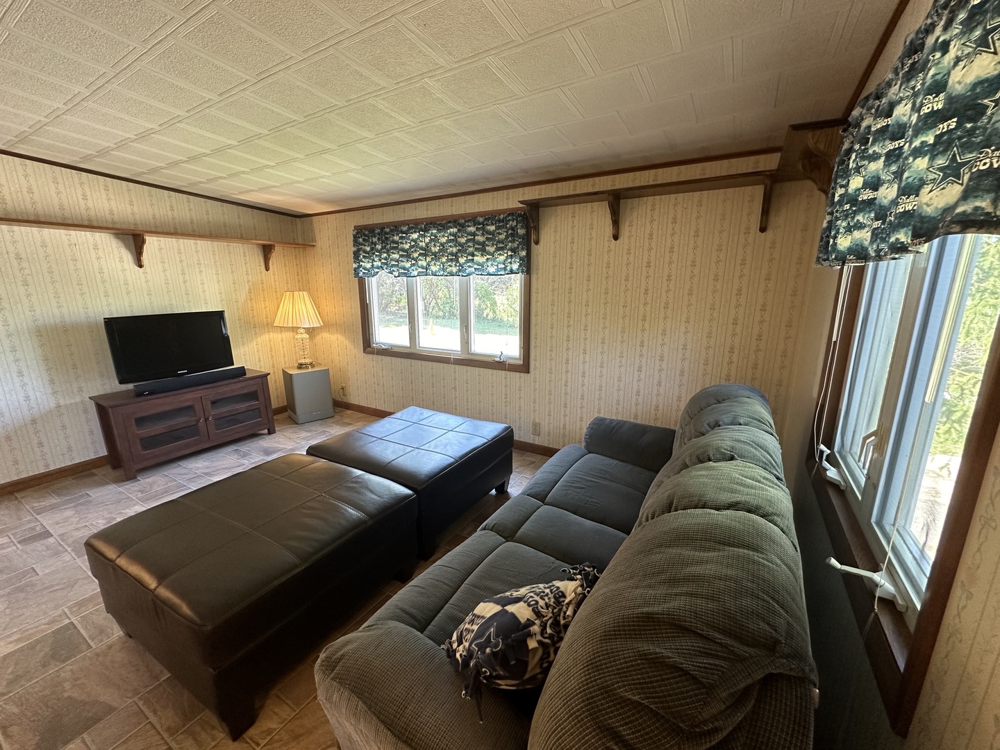 13629 Garden Plain Road Morrison, IL 61270 - Photo 13 of 28 a living room with furniture a flat screen tv and a window